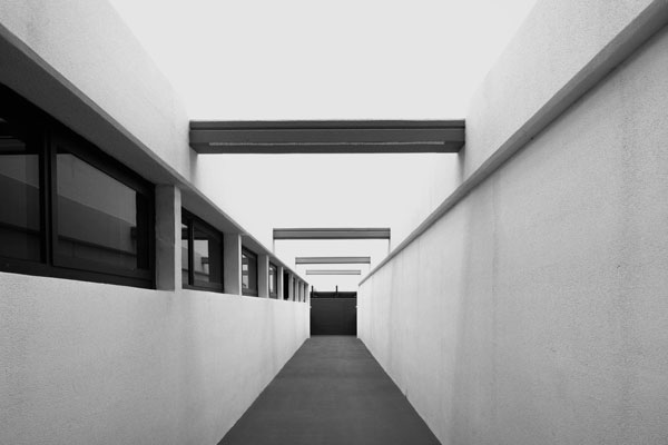 Long, clean concrete corridor in a modern commercial building.