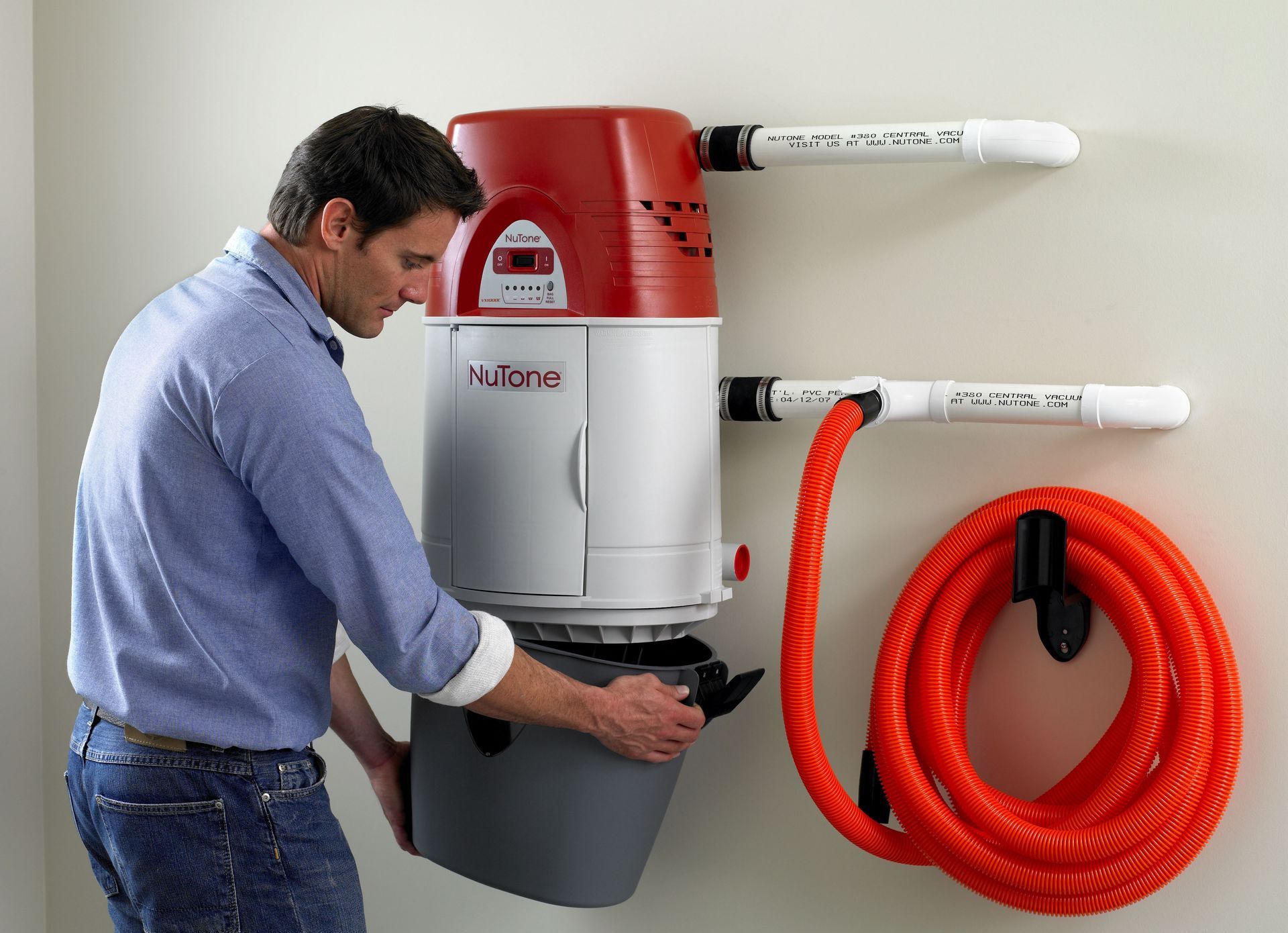 An image of a service tech installing the central vacuum canister and bag for Premier Central Vac.